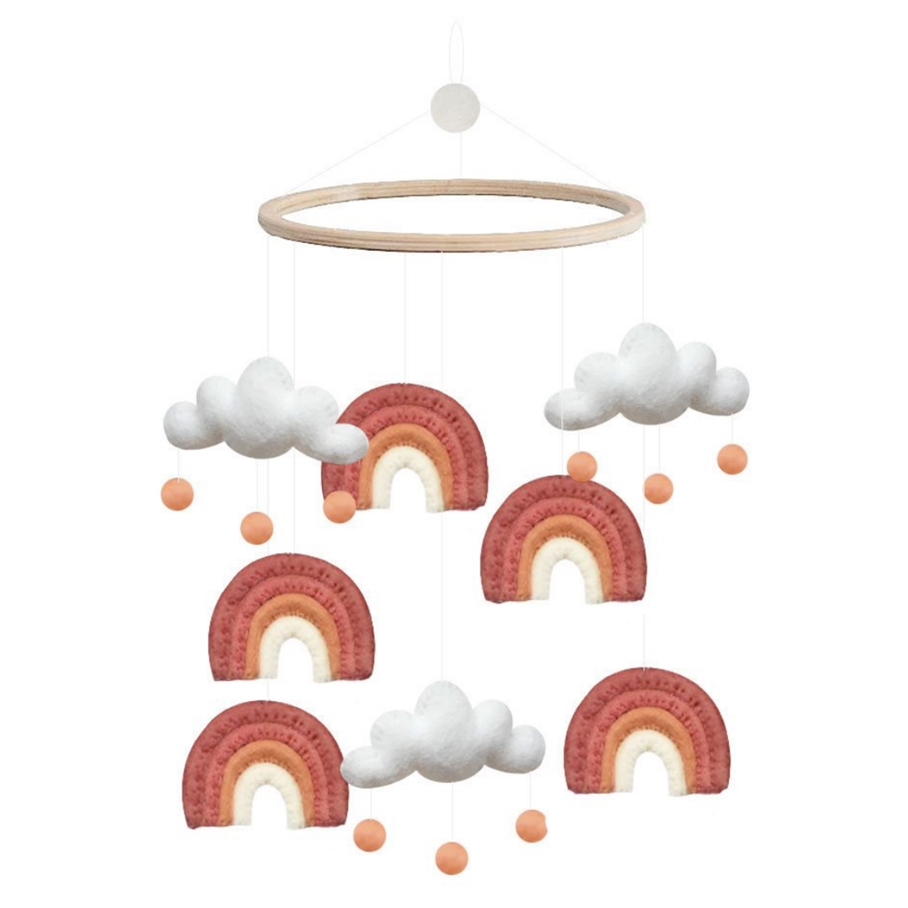 Karussell über der Krippe mit Regenbogen und Wolken