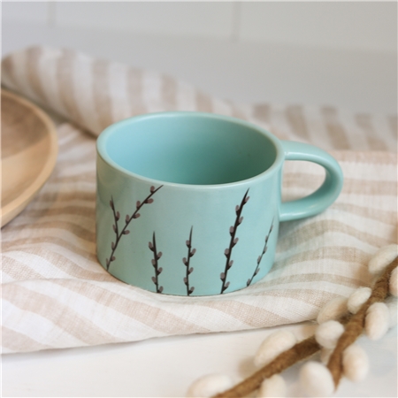 Pastellgrüner Becher mit Katzenmotiv